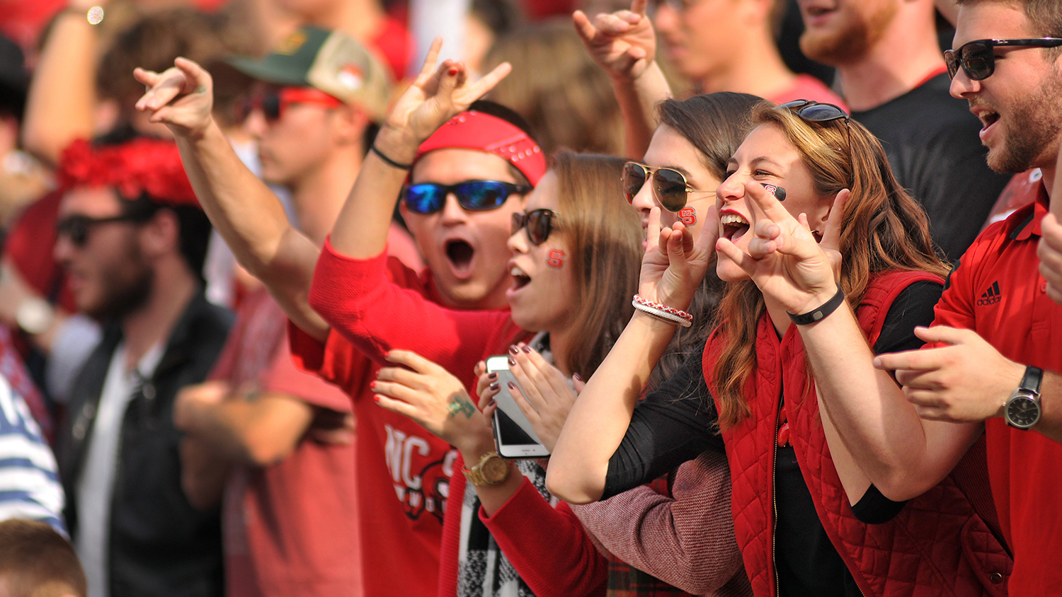 NC State students showing their school spirit at a wolfpack game
