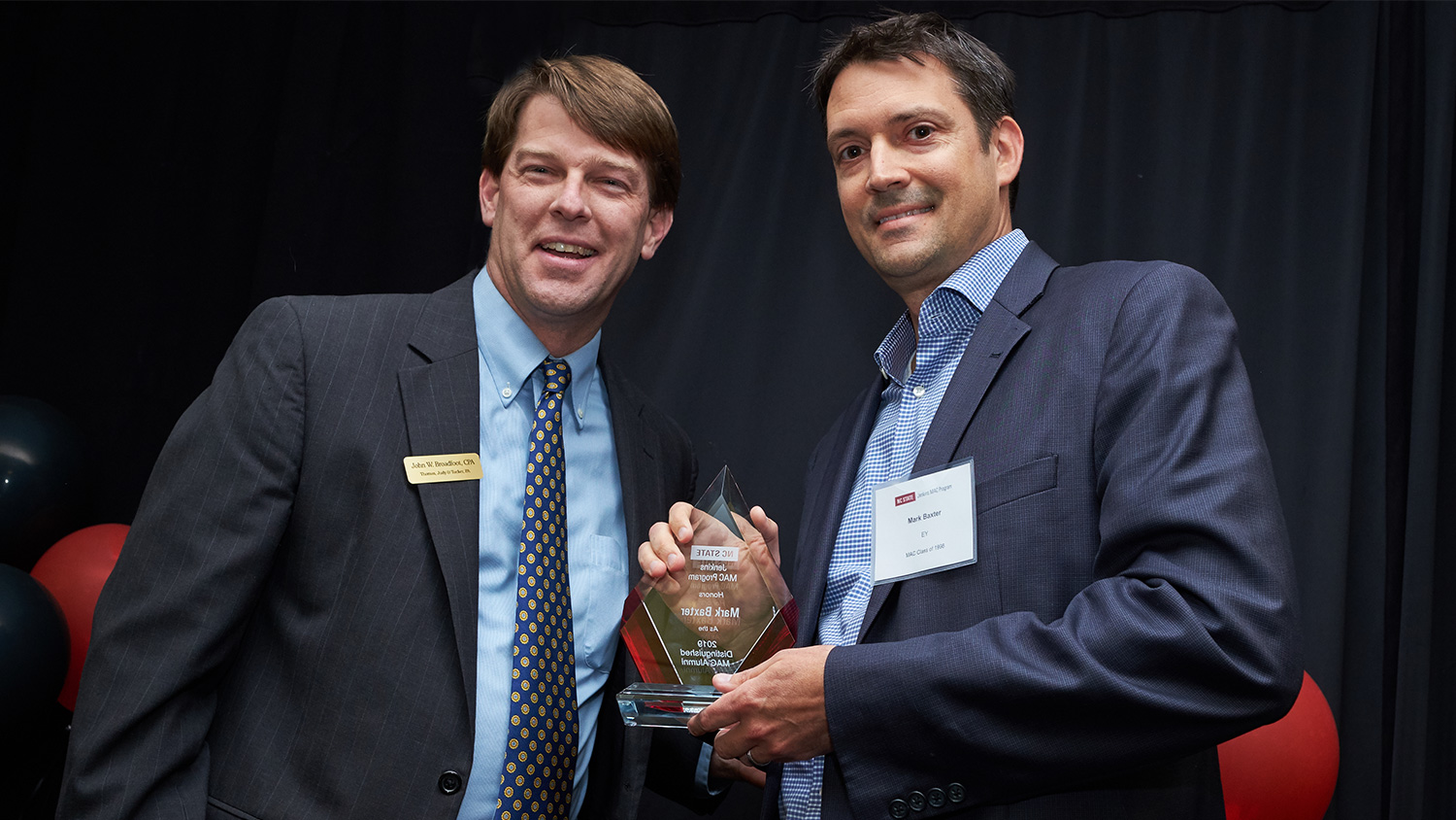 John Broadfoot, left, presents NC State Jenkins MAC Program’s inaugural Distinguished Alumni Award to Mark Baxter at the program's 25th Anniversary celebration.