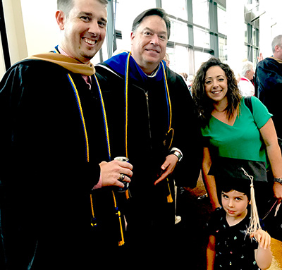 Jason Davidson and Jon Carr, left, with Davidson's wife, Dana, and son, Liam, right. 