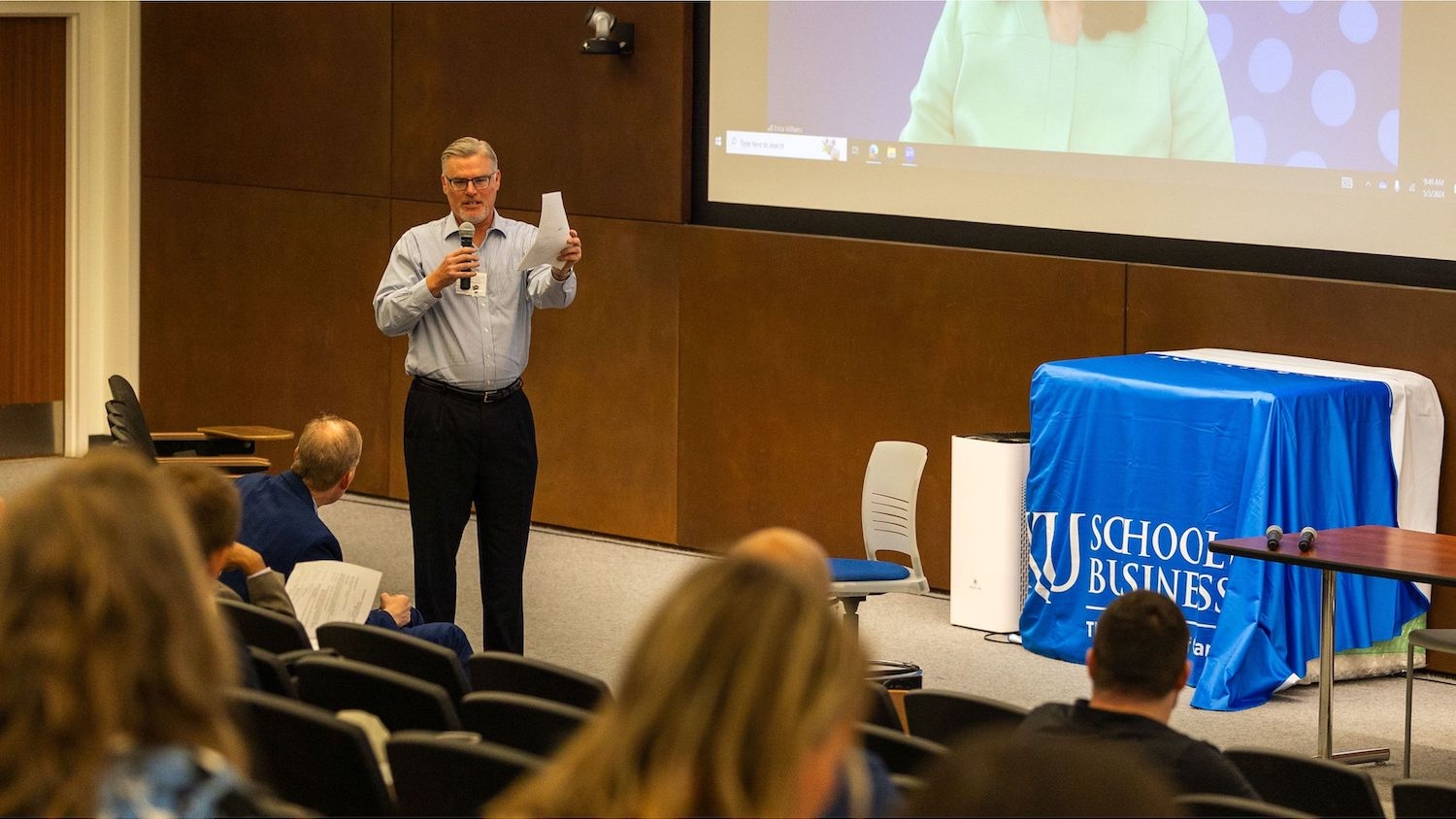 Professor Joseph Brazel talks to a gathering of scholars in an auditorium