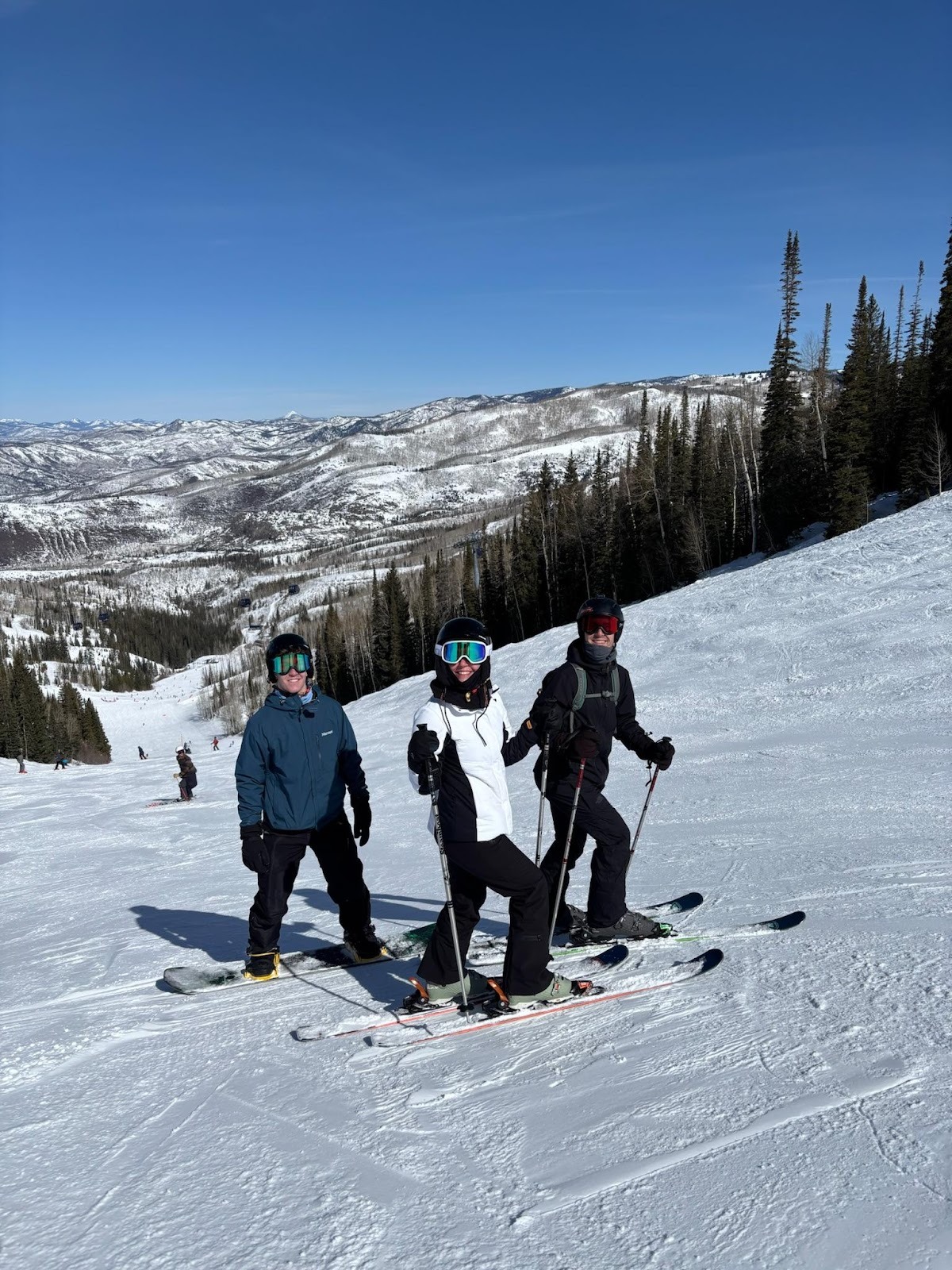 Three people skiing on a snowy mountain.
